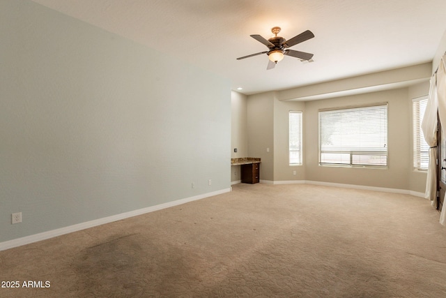 2701 E Caldwell St, Phoenix, AZ 85042 - spare room with baseboards, a ceiling fan, and light carpet
