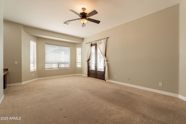 2701 E Caldwell St, Phoenix, AZ 85042 - spare room featuring ceiling fan, light colored carpet, and baseboards