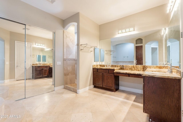 2701 E Caldwell St, Phoenix, AZ 85042 - full bath with tile patterned floors, walk in shower, baseboards, and vanity