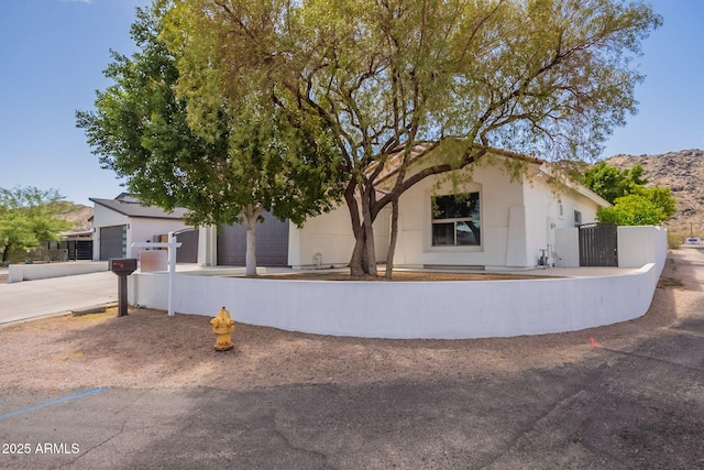2701 E Caldwell St, Phoenix, AZ 85042 - view of front of home featuring stucco siding, fence, and concrete driveway