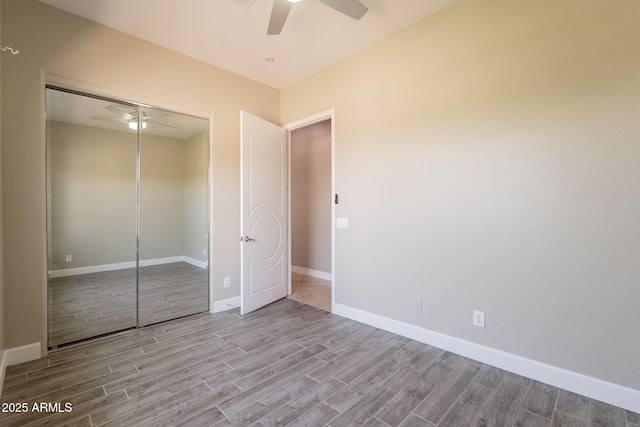2701 E Caldwell St, Phoenix, AZ 85042 - unfurnished bedroom featuring a closet, baseboards, and wood finished floors