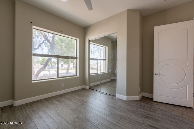 2701 E Caldwell St, Phoenix, AZ 85042 - unfurnished bedroom with baseboards, multiple windows, and a closet