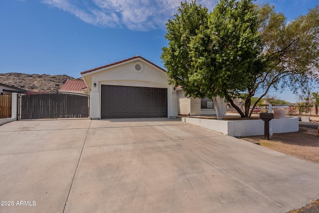 2701 E Caldwell St, Phoenix, AZ 85042 - view of front of property with a garage, stucco siding, driveway, and fence