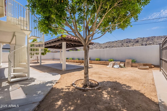 2701 E Caldwell St, Phoenix, AZ 85042 - view of yard featuring a fenced backyard, a patio area, a mountain view, and stairway