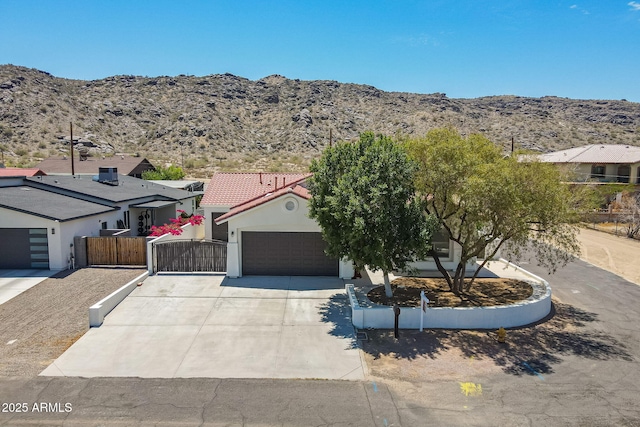 2701 E Caldwell St, Phoenix, AZ 85042 - view of front of house with a garage, fence, a mountain view, driveway, and a tile roof