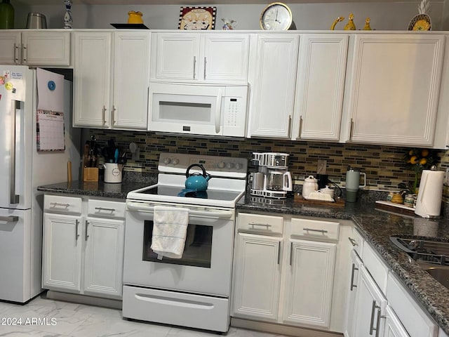 kitchen featuring white appliances, white cabinetry, dark stone countertops, and tasteful backsplash