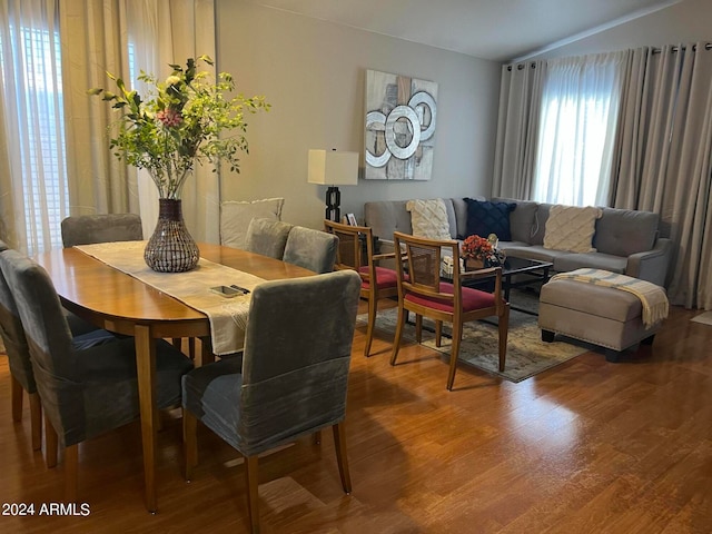 dining area with hardwood / wood-style flooring and lofted ceiling