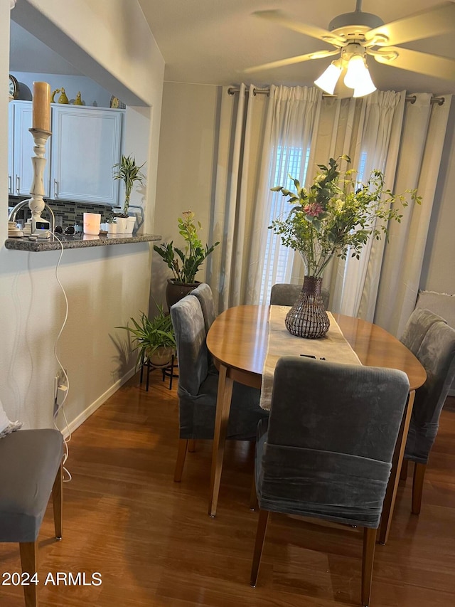 dining room with ceiling fan and hardwood / wood-style flooring