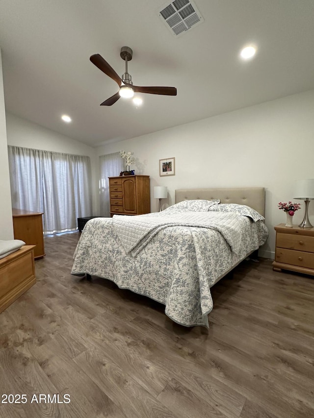 bedroom featuring vaulted ceiling, ceiling fan, wood finished floors, and visible vents