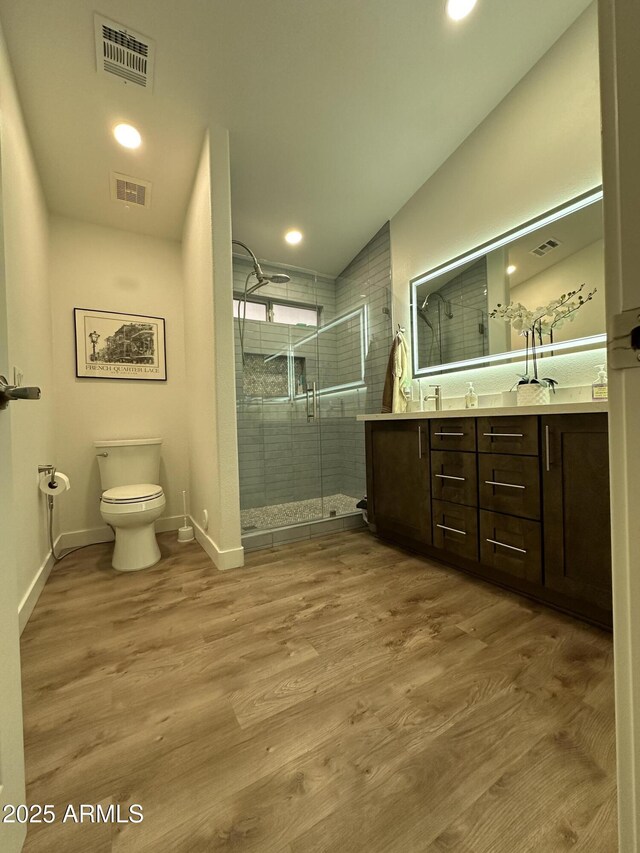 bathroom featuring toilet, wood finished floors, and visible vents