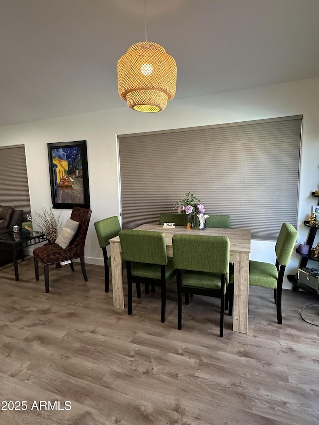 dining space with wood finished floors