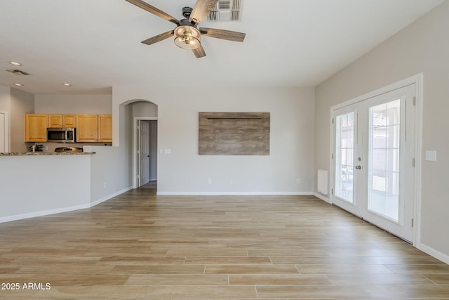 6317 S Kimberlee Way, Chandler, AZ 85249 - unfurnished living room featuring a ceiling fan, arched walkways, recessed lighting, light wood finished floors, and baseboards