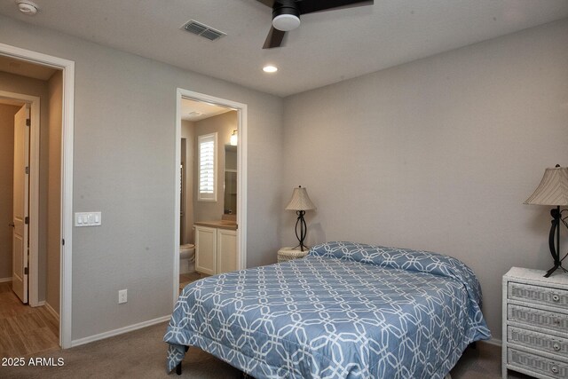 26421 W Zachary Dr, Buckeye, AZ 85396 - carpeted bedroom featuring visible vents, baseboards, ceiling fan, recessed lighting, and connected bathroom