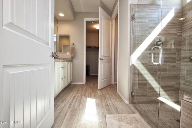 26421 W Zachary Dr, Buckeye, AZ 85396 - full bathroom with a stall shower, vanity, baseboards, and recessed lighting