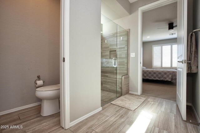 26421 W Zachary Dr, Buckeye, AZ 85396 - ensuite bathroom featuring visible vents, baseboards, toilet, ensuite bath, and a stall shower