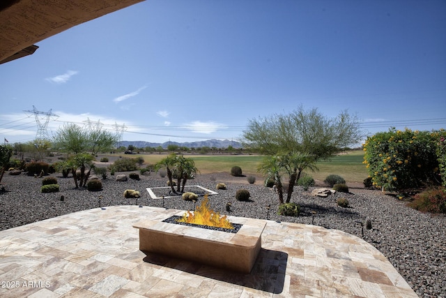 26421 W Zachary Dr, Buckeye, AZ 85396 - view of patio / terrace with a fire pit and a mountain view