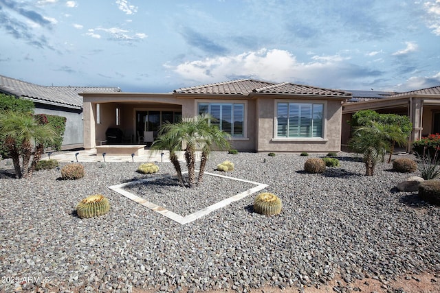 26421 W Zachary Dr, Buckeye, AZ 85396 - back of property with a patio, stucco siding, and a tile roof