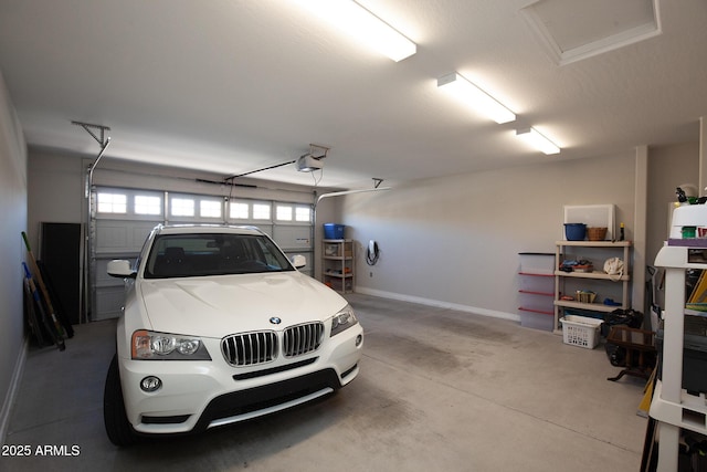 26421 W Zachary Dr, Buckeye, AZ 85396 - garage with baseboards and a garage door opener