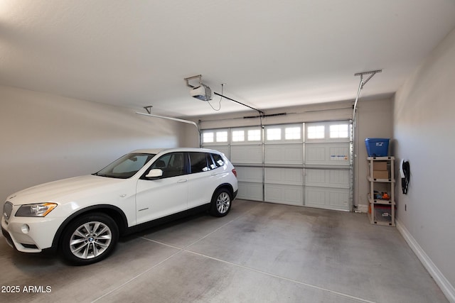 26421 W Zachary Dr, Buckeye, AZ 85396 - garage with baseboards and a garage door opener