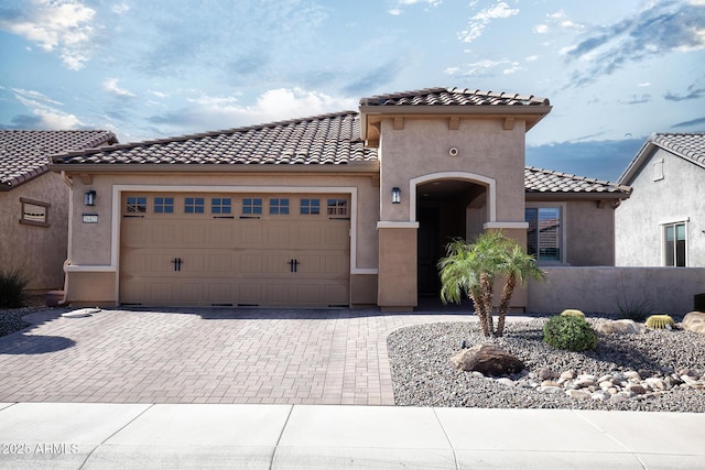 26421 W Zachary Dr, Buckeye, AZ 85396 - mediterranean / spanish house with an attached garage, a tiled roof, stucco siding, and decorative driveway