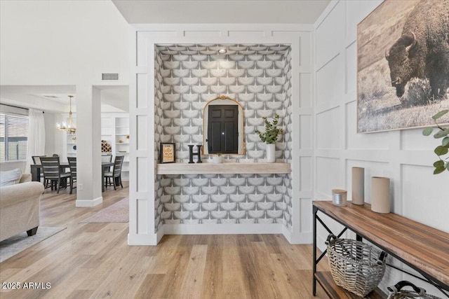 2466 E Harrison Ct, Gilbert, AZ 85295 - bar area featuring a chandelier, light wood finished floors, and baseboards