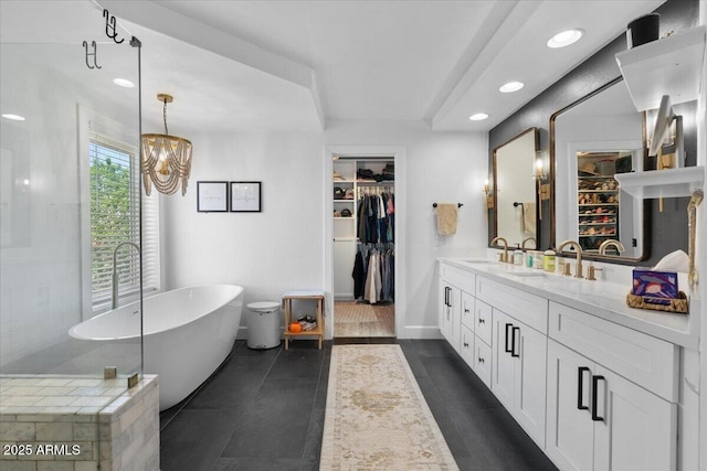 2466 E Harrison Ct, Gilbert, AZ 85295 - full bathroom with double vanity, a freestanding bath, a walk in closet, recessed lighting, and a chandelier