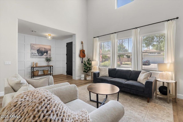 2466 E Harrison Ct, Gilbert, AZ 85295 - living area with wood finished floors, baseboards, and a towering ceiling