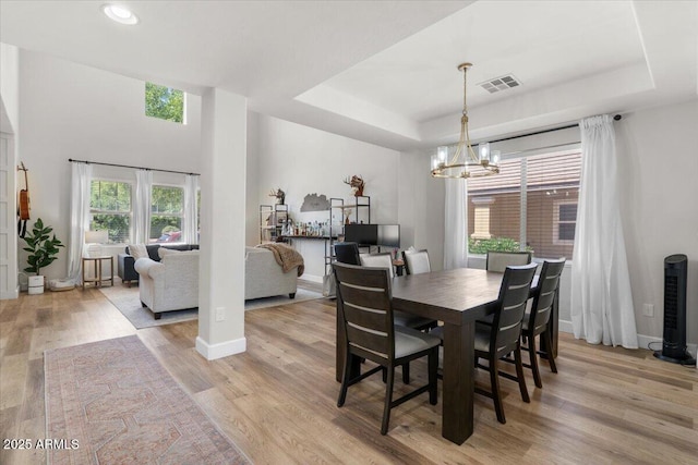 2466 E Harrison Ct, Gilbert, AZ 85295 - dining area featuring a tray ceiling, a chandelier, light wood-style floors, recessed lighting, and baseboards