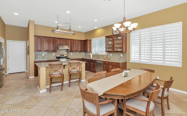 42423 N Acadia Way, Anthem, AZ 85086 - dining area featuring a chandelier, light tile patterned floors, recessed lighting, and baseboards