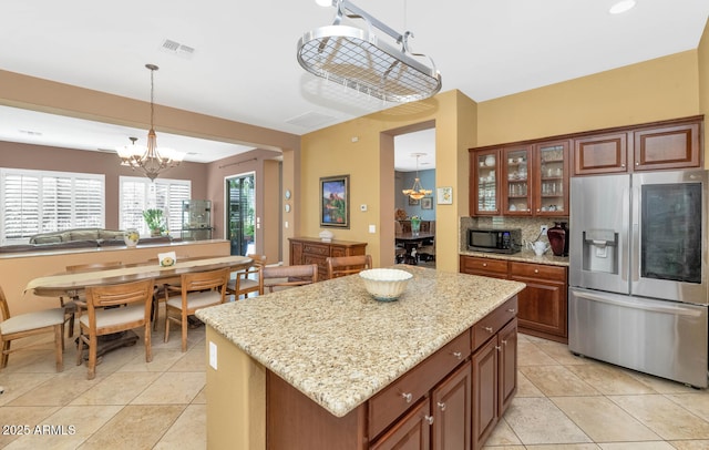 42423 N Acadia Way, Anthem, AZ 85086 - kitchen with stainless steel fridge, a chandelier, black microwave, and decorative light fixtures