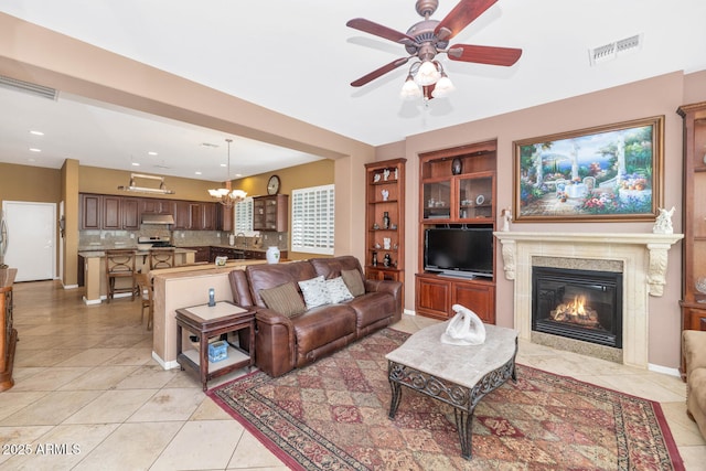 42423 N Acadia Way, Anthem, AZ 85086 - living room featuring a ceiling fan, light tile patterned floors, a premium fireplace, a chandelier, and recessed lighting