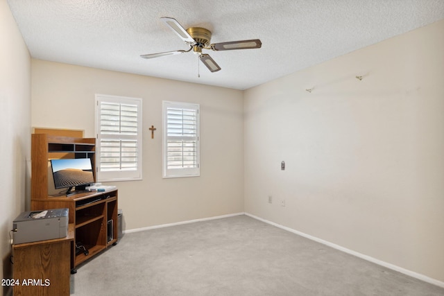 interior space featuring light colored carpet, a textured ceiling, and ceiling fan