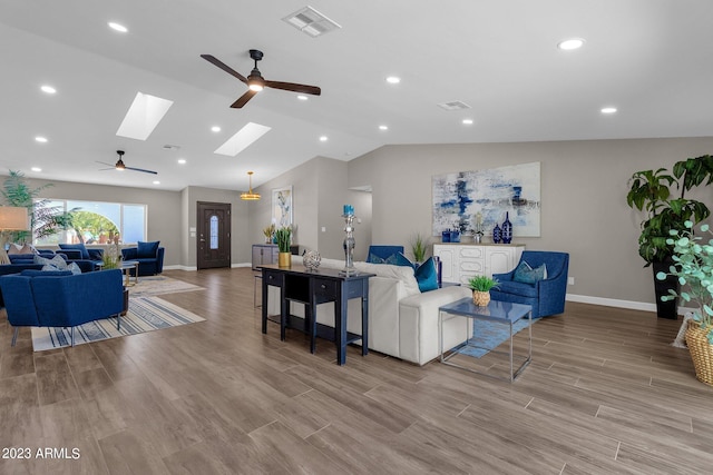 living room with light wood-type flooring, vaulted ceiling, and ceiling fan