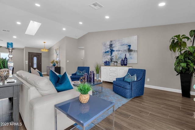 living room with wood-type flooring and vaulted ceiling with skylight