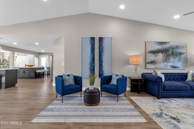 living room with hardwood / wood-style floors and lofted ceiling