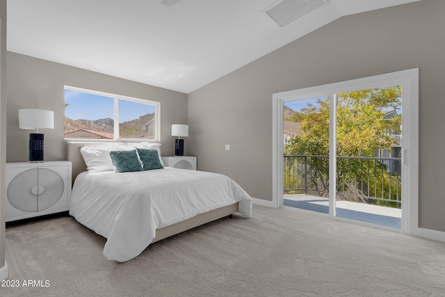 bedroom with lofted ceiling, multiple windows, and light carpet