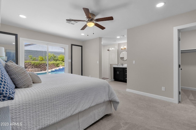 carpeted bedroom featuring sink, access to exterior, ceiling fan, and ensuite bathroom