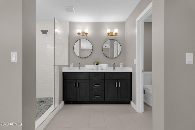 bathroom with walk in shower, vanity, and toilet