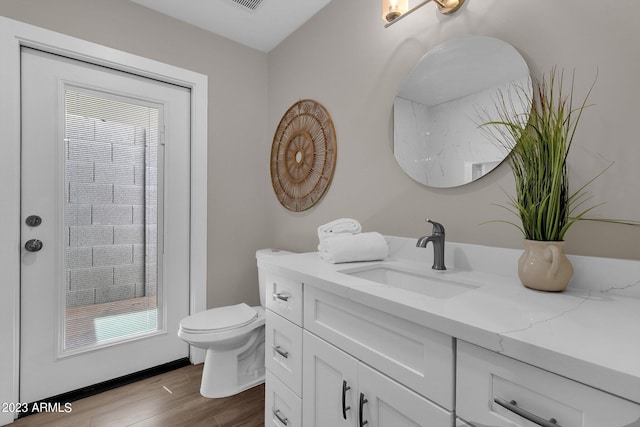 bathroom featuring hardwood / wood-style floors, vanity, and toilet