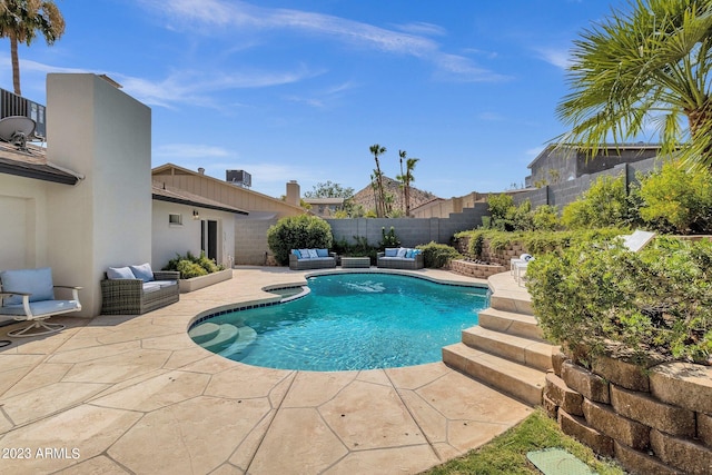 view of pool with an outdoor living space and a patio area