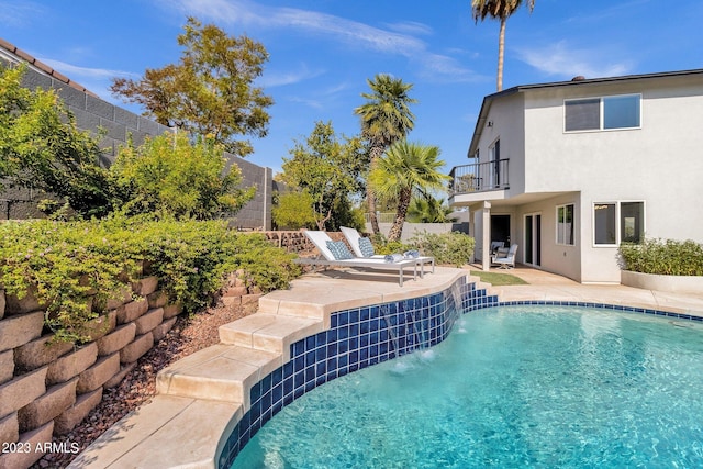 view of swimming pool featuring a patio and pool water feature