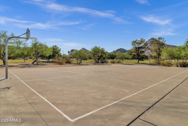 view of tennis court with basketball court and a mountain view