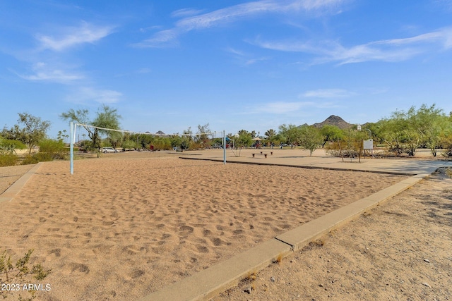 surrounding community featuring volleyball court and a mountain view