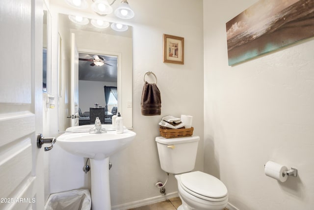 half bath featuring tile patterned floors, baseboards, a ceiling fan, and toilet