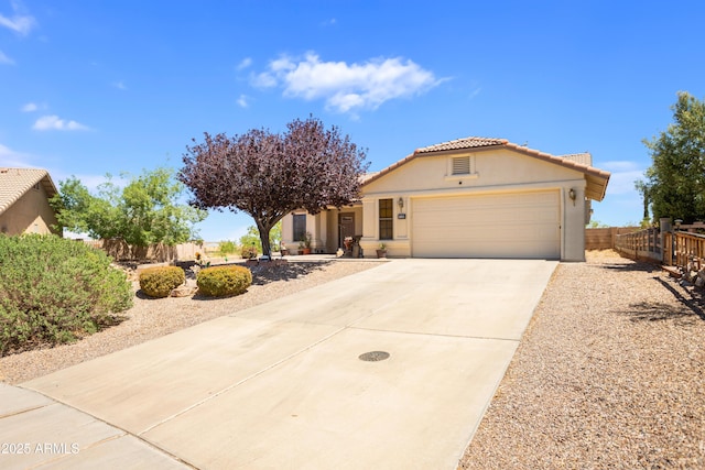 single story home with fence, stucco siding, a tiled roof, an attached garage, and driveway