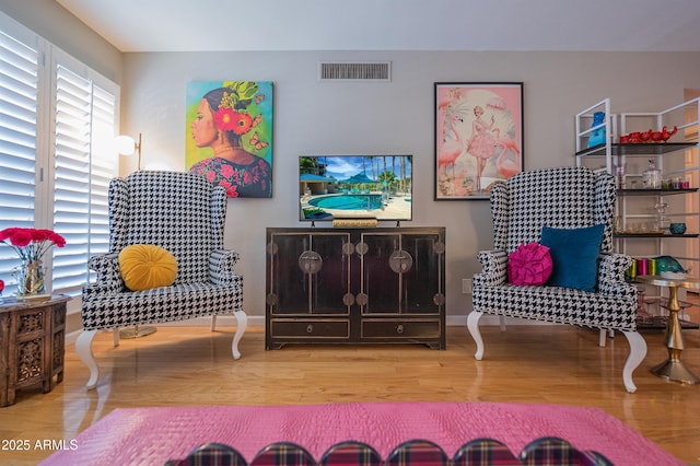 5102 N 31st Pl Unit 432, Phoenix, AZ 85016 - sitting room featuring wood finished floors, visible vents, and baseboards