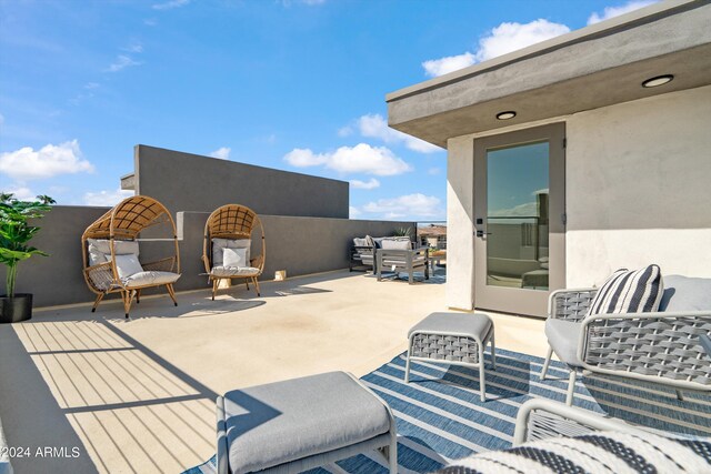 view of patio featuring an outdoor living space and a balcony