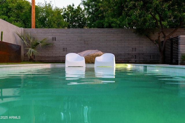 view of swimming pool featuring a fenced backyard