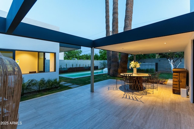 view of patio / terrace with a fenced in pool, outdoor dining area, and a fenced backyard