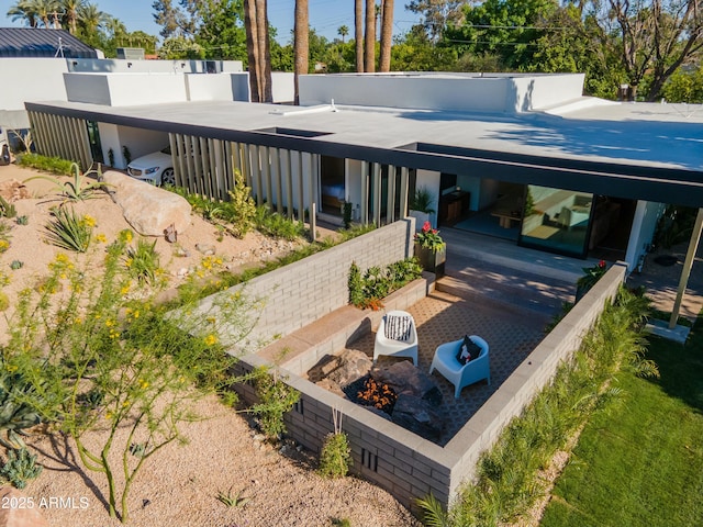 back of property featuring an outdoor fire pit